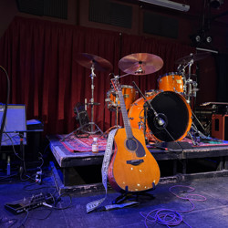 The Japanese Yamaha FG5 acoustic guitar, Orange and Marshall amps and drum kit used at the show. 